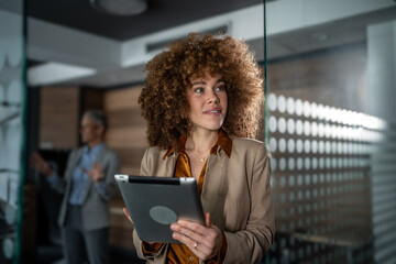 Businesswoman holding tablet during corporate office meeting