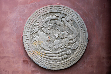 Decorative stone carving featuring dragon and phoenix