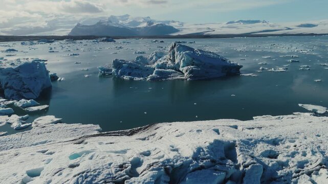 Majestic icebergs breaking off a melting glacier and gliding through Iceland&rsquo;s J&ouml;kuls&aacute;rl&oacute;n lagoon, creating a breathtaking Arctic landscape.