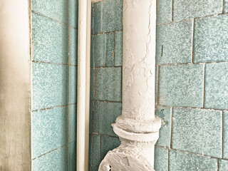 Decorative light blue tiles with an old white column in a retro building corner