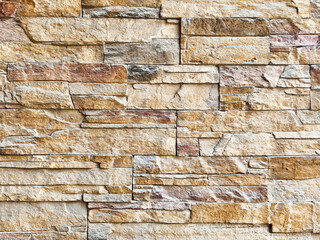 Textured stone wall with natural variation and space for message placement in interior design setting
