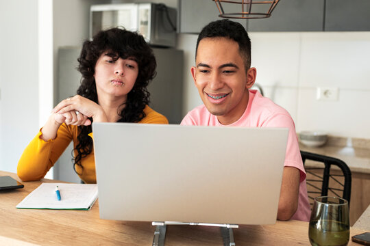 Relaxed couple building digital life in modern apartment