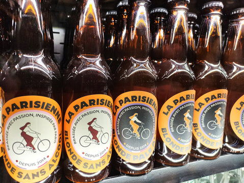Paris, France - November 22, 2025: La Parisienne non-alcoholic beverage bottles displayed on shelf, featuring vibrant labels with bicycle illustrations and appealing branding for refreshing enjoyment