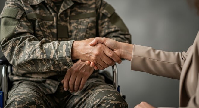 disabled veteran in camouflage uniform shaking hands with civilian woman. soldier sitting in wheelchair. gratitude, respect and support concept. banner with copy space. social services.