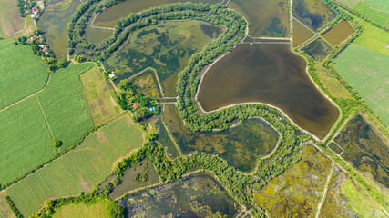 Top view of flooded rice fields and farmland in the countryside. Agricultural landscape. Hinigaran River. Negros, Philippines