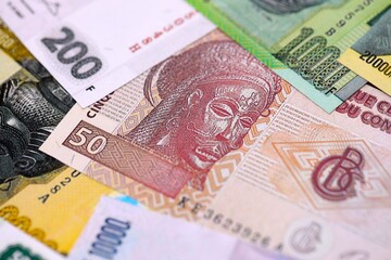 Fototapeta premium Congolese franc money bills in big amount on table close up. Rich life concept in Democratic Republic of Congo. Business and economy