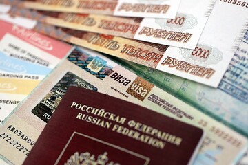 Fragment of Russian Federation visa in passport page and russian money close up. Concept of travel and tourism in Russia
