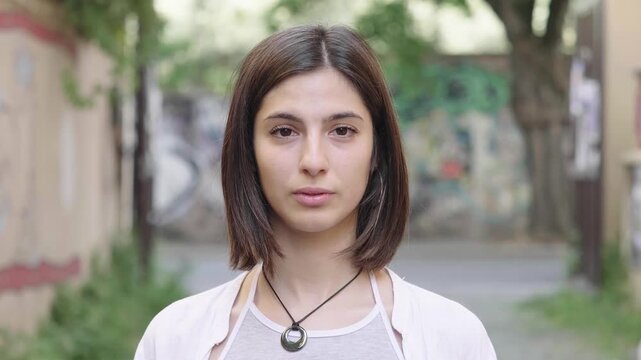 Young girl smiles at camera after initial look