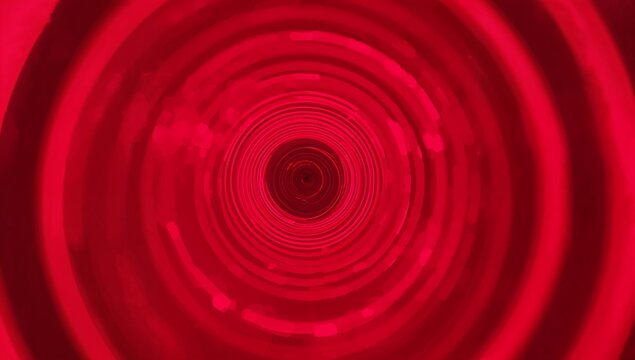 Drawing eye toward illuminated tunnel in light installation, with red LED rings and dark aperture