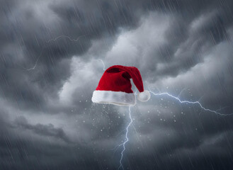 Red Santa Hat Floating in a Blue Sky with Soft Clouds christmas holiday