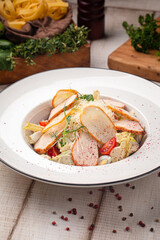 Fresh Caesar salad with grilled chicken slices crunchy lettuce tomatoes and parmesan on a white plate