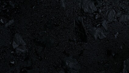 Displaying dark textured surface featuring scattered crumpled chunks and glossy droplets in macro
