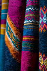 A close-up of traditional woven mountain textiles, showcasing intricate patterns and textures, a testament to generational craft.
