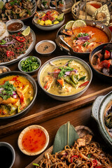 many different thai food dishes on table in modern restaurant in bangkok thailand