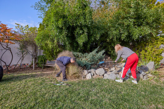 A middle-aged man and his wife work in the garden and do various maintenance activities. - Powered by Adobe