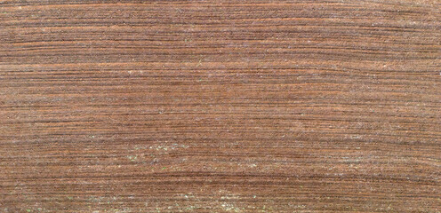 Horizontal aerial texture of a ploughed field with fine horizontal soil lines creating a smooth and uniform agricultural background
