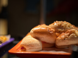 Assorted Breads on an Orange Tray
