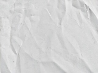 Crumpled kraft old white paper texture background with copy space for design. Wrinkled white kraft paper surface with natural creases and shading.