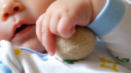 Adorable Baby Hand Grasping Soft Toy Close-Up