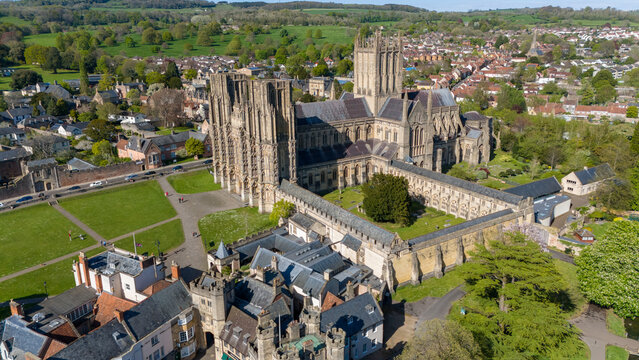 Aerial view of the majestic Wells Cathedral, a beacon of architectural grandeur amidst the verdant Cathedral Green, its towers reaching skyward, Wells, England, United Kingdom.