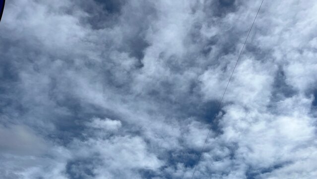 Abstract Cloud Texture: Dynamic Swirl of White and Gray Altocumulus Clouds