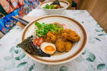 Japanese ramen noodle soup with chicken, egg, scallions, rice noodles