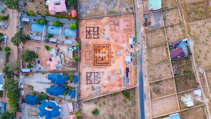 Aerial view of construction site with foundations etched in the ochre earth contrasts with surrounding greenery, Modoji Road, Katsina, Katsina, Nigeria.