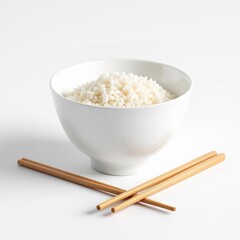 A white bowl filled with cooked white rice served with a pair of wooden chopsticks on a white background