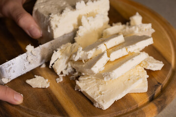 sliced white cheese on wooden cutting board