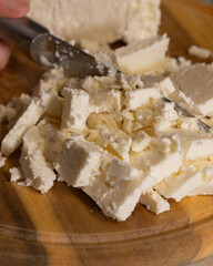 sliced white cheese on wooden cutting board