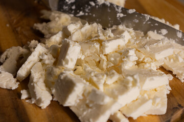 sliced white cheese on wooden cutting board