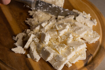 sliced white cheese on wooden cutting board