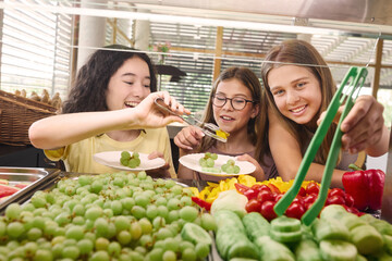 Naklejka premium Children selecting fresh fruits and vegetables in a school cafeteria setting