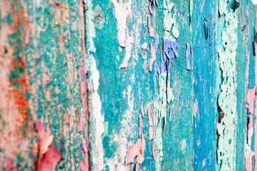 Texture of peeling paint on weathered wood, peeling paint of turquoise color on the wooden surface