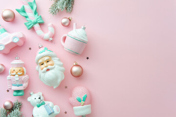 Christmas holiday flat lay composition with pastel pink and mint Christmas ornaments on the left side, copy space.