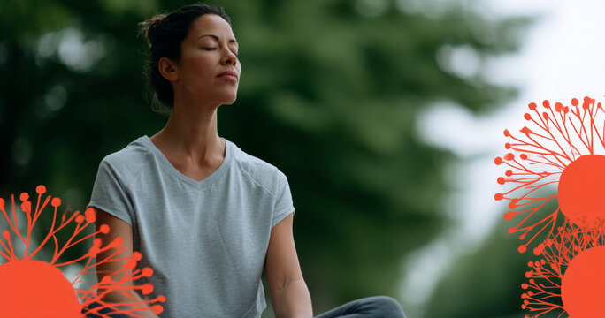 Woman meditating outdoors with eyes closed in peaceful natural setting surrounded by greenery and soft light