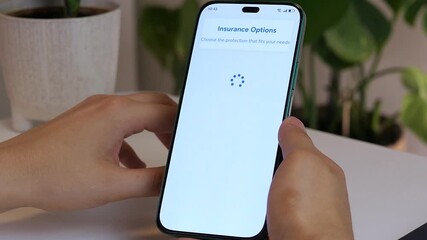 Closeup of a mans hands browsing an insurance app, finding a specific policy, and delving into its terms and price. This clip effectively visualizes a targeted search and detailed evaluation of a