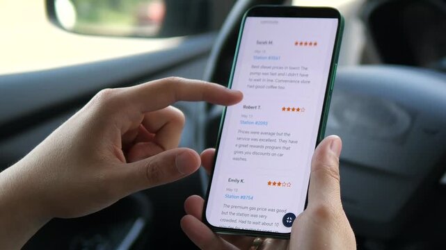 Closeup of a drivers hands scrutinizing user reviews and star ratings for a service on a mobile app. This clip highlights the importance of social proof and community feedback in the modern consumers