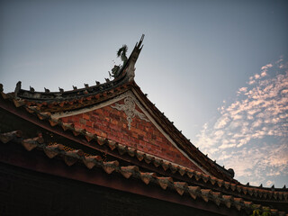 Traditional Red - Brick Ancient Building Roof with Dusk Clouds