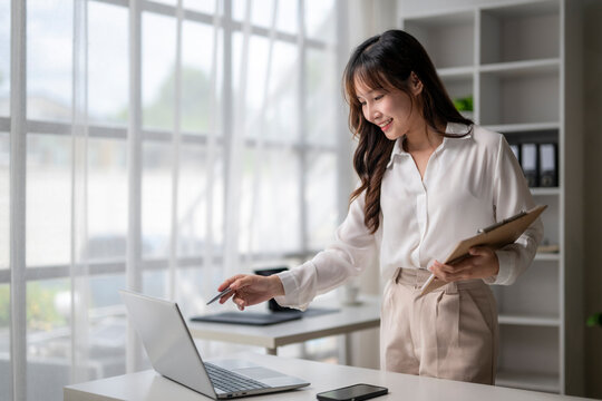 Young professional woman working from home office and using laptop computer