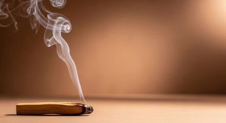 A smoldering Palo Santo stick releases fragrant smoke against a warm brown backdrop creating a calming and spiritual atmosphere