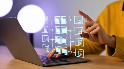 A business professional interacting with a futuristic digital interface, managing a complex workflow automation flowchart on a laptop computer