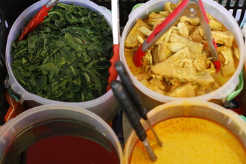 Nasi Padang traditional Sumatra Indonesian food served with spicy side dishes like beef, chicken, fish, and vegetables, rich in flavorful spices.