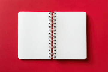 Open spiral notebook with blank pages on vibrant red background, showcasing potential for creativity and design with copy space