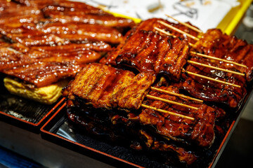 Glazed Grilled Eel Skewers Displayed at Japanese Market