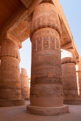 Karnak temple in the heritage city of Luxor in Egypt. Giant row of columns with carved hieroglyph - Ceiling and floor level in the same photo