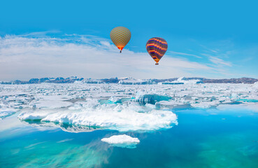 Hot air balloon flying over Tiniteqilaaq on Sermilik Fjord, East Greenland
