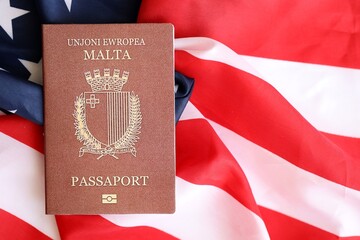 Malta passport on big waving flag of United States of America close up. US Visa and immigration...