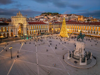 Illuminated Christmas tree in Praca do Comercio at twilight in Lisbon