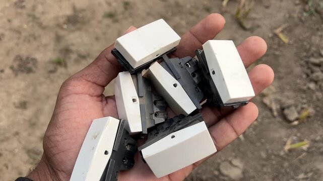 Electric Switch Button Held in Hand Close-Up